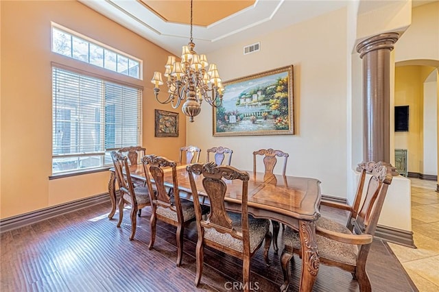 dining room featuring arched walkways, visible vents, plenty of natural light, and decorative columns