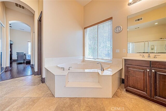 full bathroom featuring vanity, tile patterned floors, a bath, and visible vents