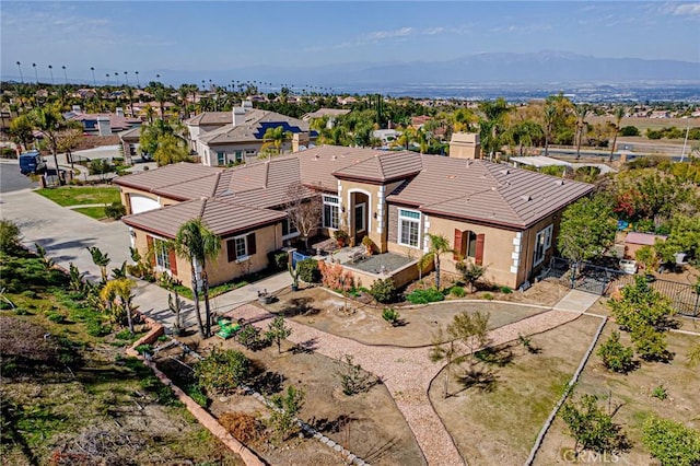 birds eye view of property with a mountain view