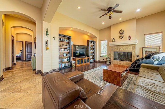 living room with recessed lighting, light tile patterned floors, baseboards, ceiling fan, and a tile fireplace