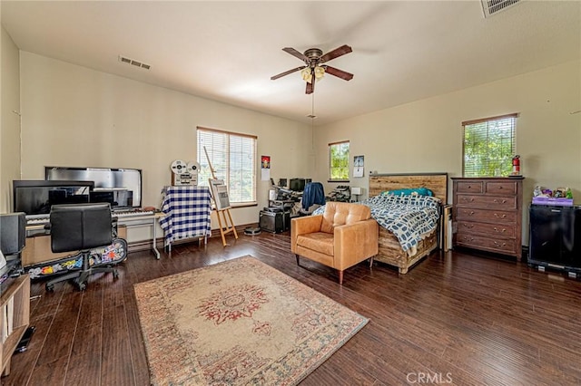 bedroom with multiple windows, wood finished floors, and visible vents