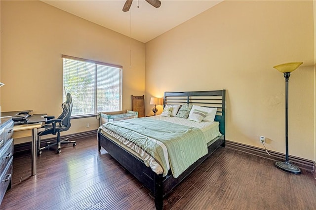 bedroom with ceiling fan, baseboards, wood finished floors, and vaulted ceiling