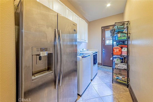 laundry area with washer and clothes dryer, cabinet space, baseboards, and light tile patterned flooring