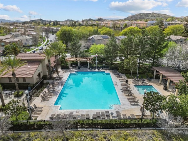 pool with a mountain view, fence, a patio area, and a pergola