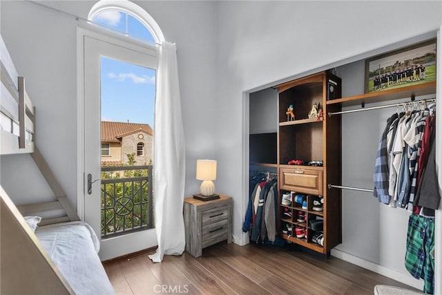 bedroom with baseboards and wood finished floors