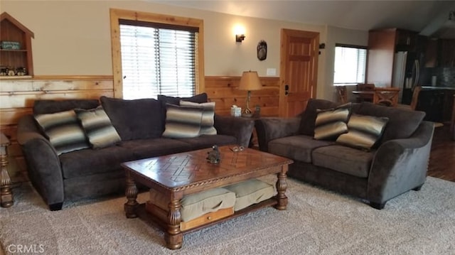 living room with a wainscoted wall and wood walls