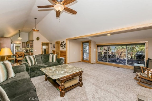 living room featuring lofted ceiling, carpet, and ceiling fan