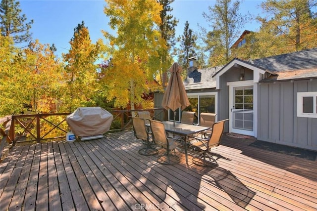 deck featuring area for grilling and outdoor dining space