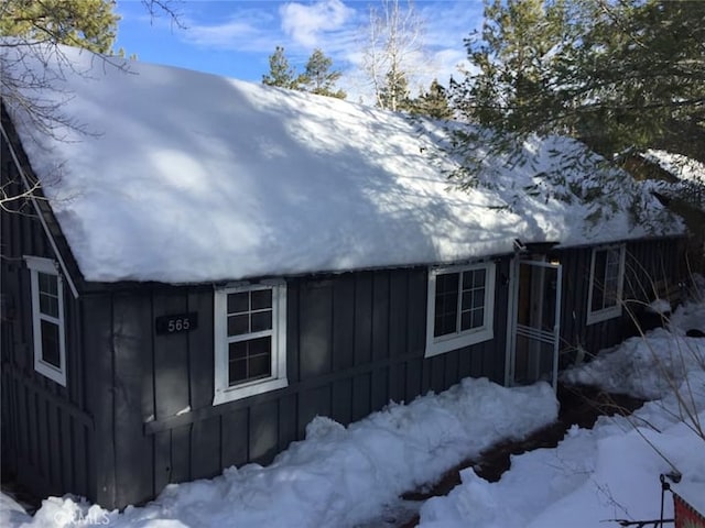 snow covered property featuring board and batten siding