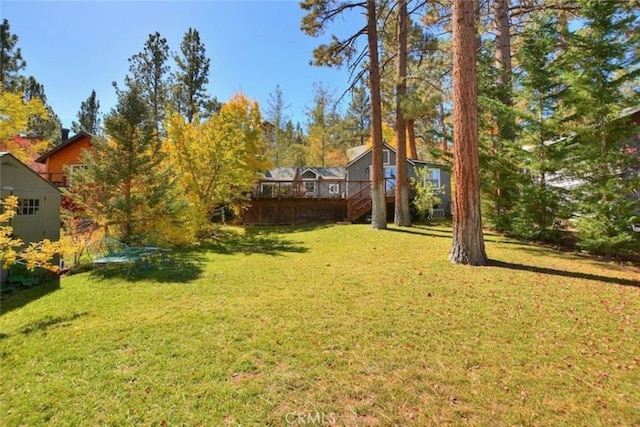 view of yard featuring a wooden deck