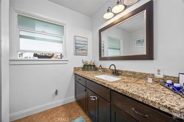 bathroom featuring baseboards, vanity, and tile patterned flooring