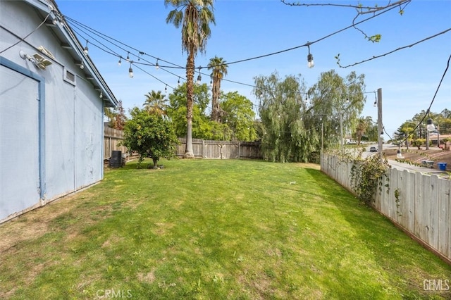 view of yard with a fenced backyard