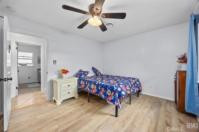 bedroom featuring visible vents, light wood-style flooring, baseboards, and a ceiling fan