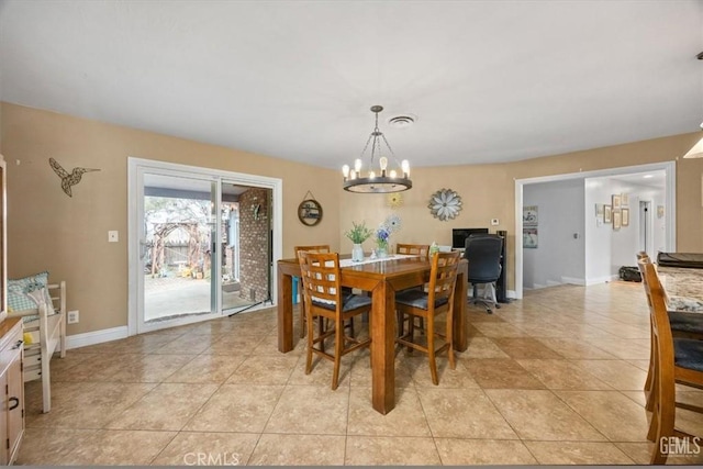 dining space featuring a chandelier, visible vents, baseboards, and light tile patterned floors