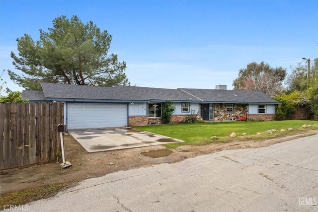 ranch-style house with fence, driveway, a front lawn, a garage, and brick siding