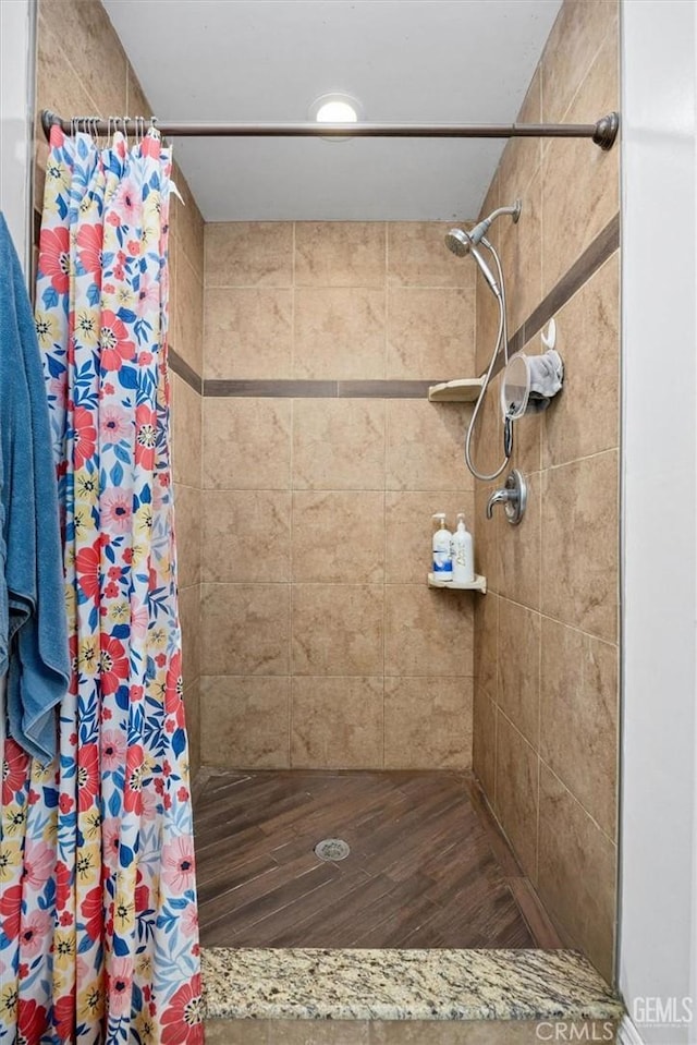 full bath featuring a shower stall