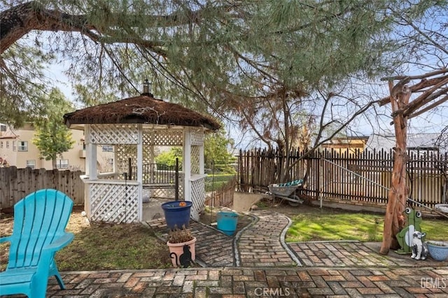 view of yard with a gazebo, a patio, and a fenced backyard