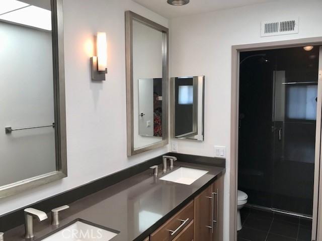 full bathroom featuring a sink, visible vents, toilet, and a stall shower