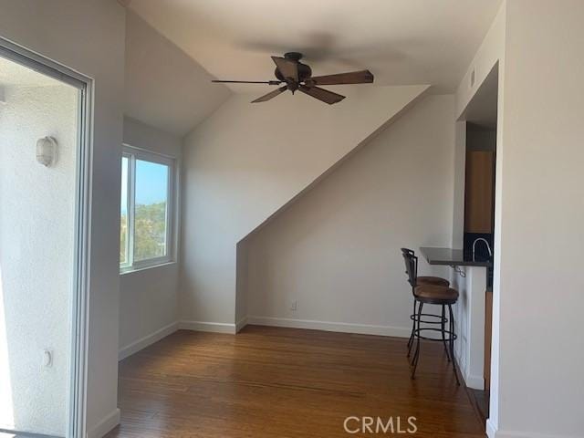 bonus room featuring ceiling fan, baseboards, wood finished floors, and vaulted ceiling