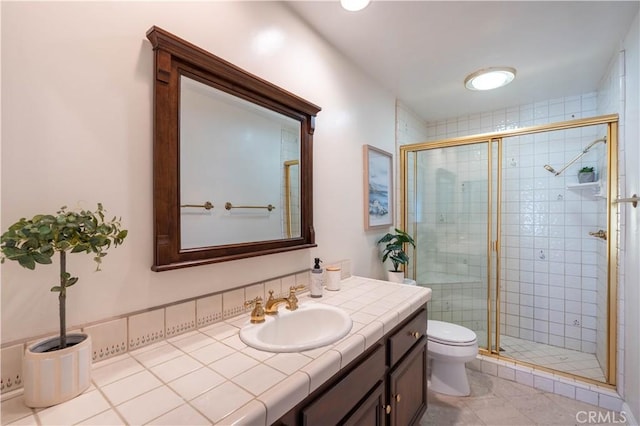 bathroom with vanity, toilet, and a shower stall