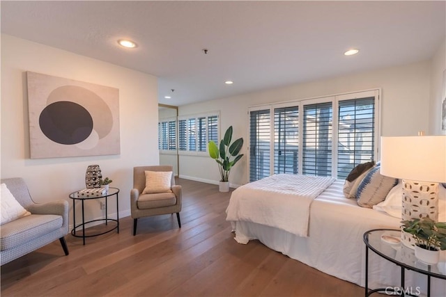 bedroom featuring recessed lighting, wood finished floors, and baseboards