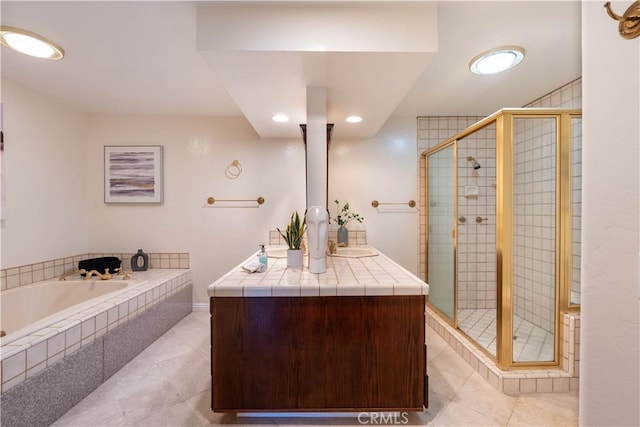 bathroom featuring a bath, tile patterned floors, a stall shower, and vanity