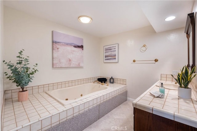 bathroom with a jetted tub and vanity