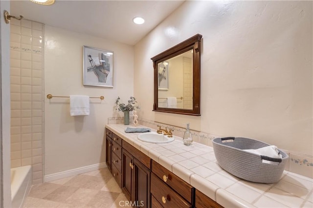 full bathroom with recessed lighting, baseboards, a bathtub, walk in shower, and vanity