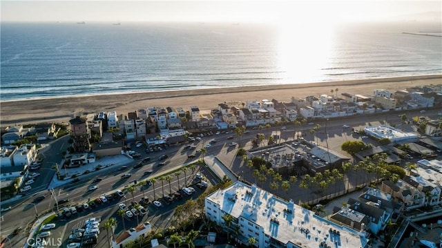 birds eye view of property featuring a water view and a beach view