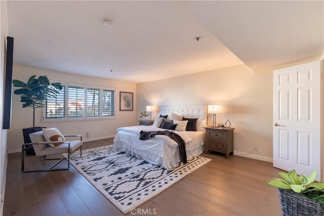 bedroom featuring baseboards and wood finished floors