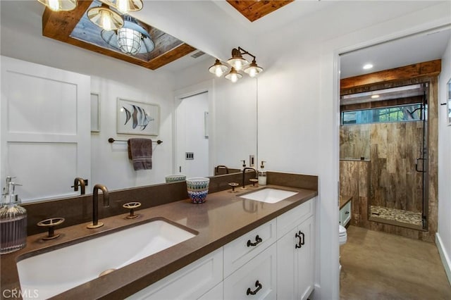 full bathroom with double vanity, a shower stall, toilet, and a sink