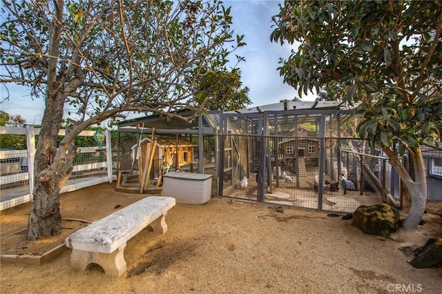 view of yard featuring exterior structure, an outdoor structure, and fence