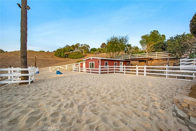 view of stable featuring a rural view