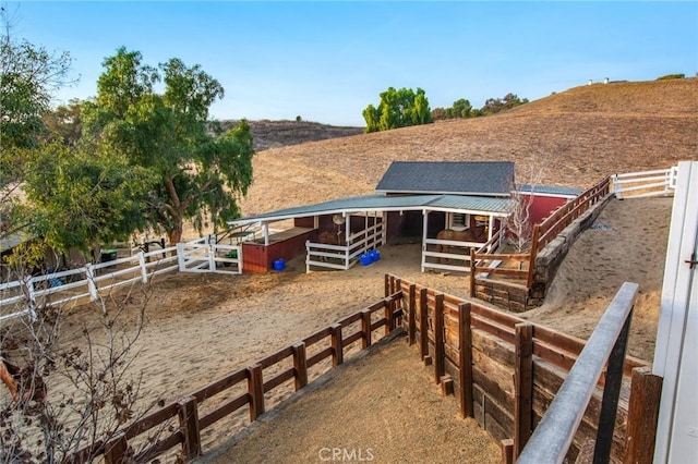 exterior space featuring an outdoor structure, a rural view, and an exterior structure