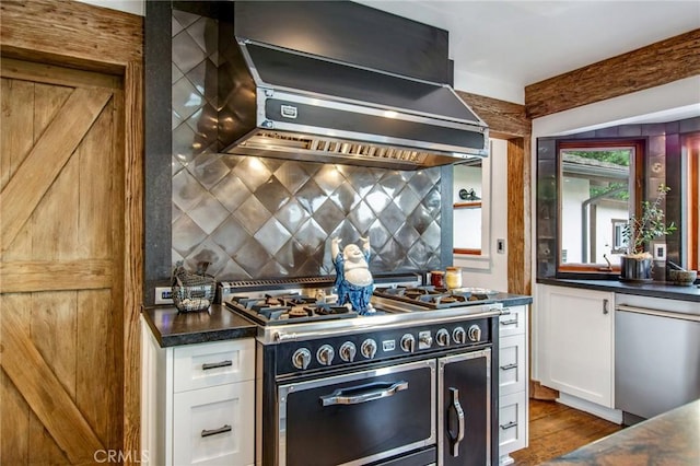 kitchen featuring stainless steel dishwasher, extractor fan, double oven range, and white cabinetry