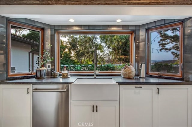 27151 Mission Hills Dr, San Juan Capistrano, CA 92675 - kitchen featuring dishwasher, a sink, white cabinets, dark countertops, and plenty of natural light