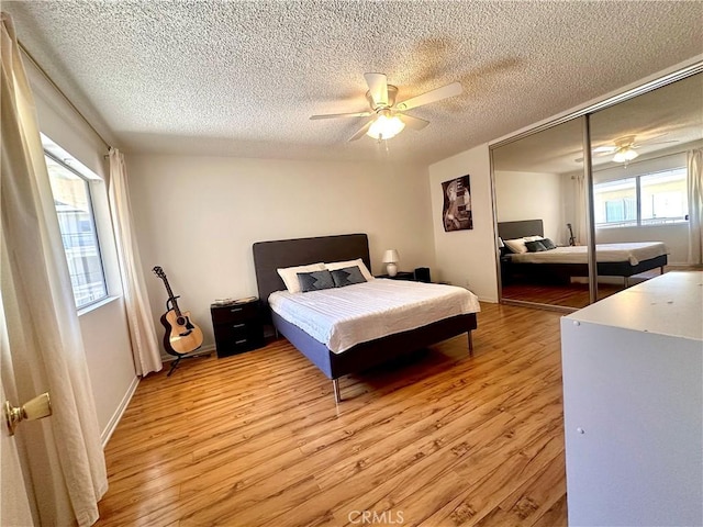 4358 Mammoth Ave Unit 14, Sherman Oaks, CA 91423 - bedroom with light wood finished floors, a textured ceiling, ceiling fan, and a closet