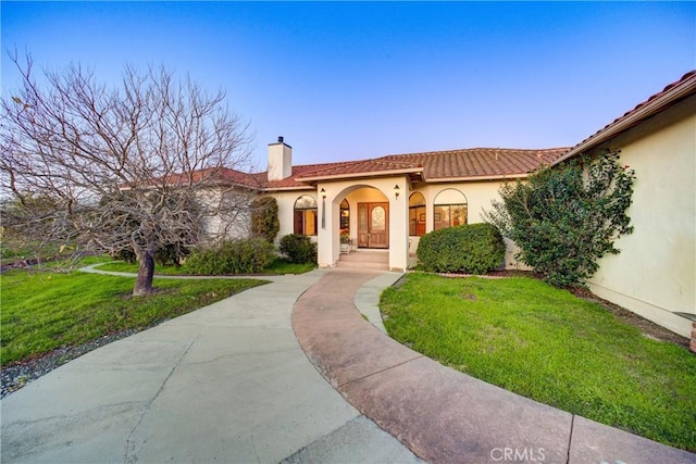 2139 Verde Canyon Rd, Arroyo Grande, CA 93420 - mediterranean / spanish-style house featuring a chimney, stucco siding, a front yard, and a tile roof