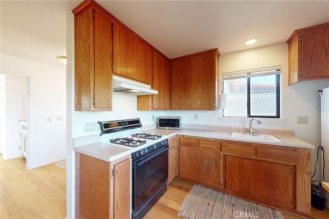 2139 Verde Canyon Rd, Arroyo Grande, CA 93420 - kitchen featuring white range with gas cooktop, under cabinet range hood, light wood-style floors, light countertops, and brown cabinets