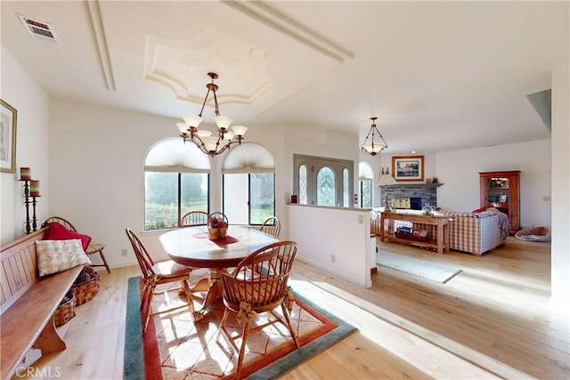 2139 Verde Canyon Rd, Arroyo Grande, CA 93420 - dining space featuring a chandelier, light wood-style floors, and a fireplace