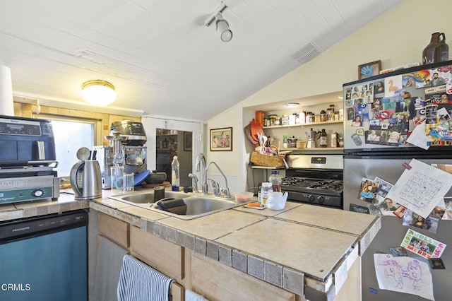 kitchen featuring visible vents, a sink, stainless steel appliances, vaulted ceiling, and rail lighting