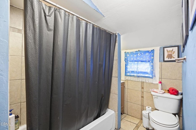 full bath featuring tile patterned flooring, tile walls, shower / bath combination with curtain, and toilet