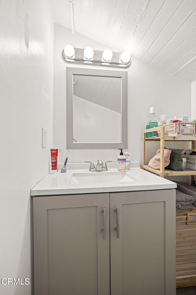 bathroom featuring vanity and vaulted ceiling