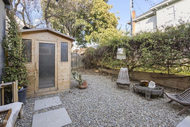 view of yard featuring an outdoor structure and a fenced backyard