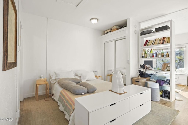 bedroom with a closet and light wood-style floors