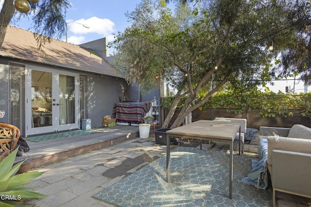 view of patio / terrace featuring french doors and fence