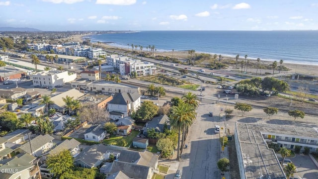 drone / aerial view with a water view and a beach view