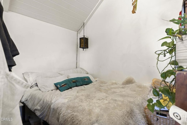 bedroom with wood ceiling and vaulted ceiling