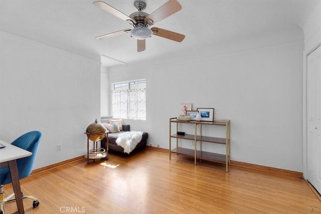 office space featuring light wood-style flooring, baseboards, and ceiling fan