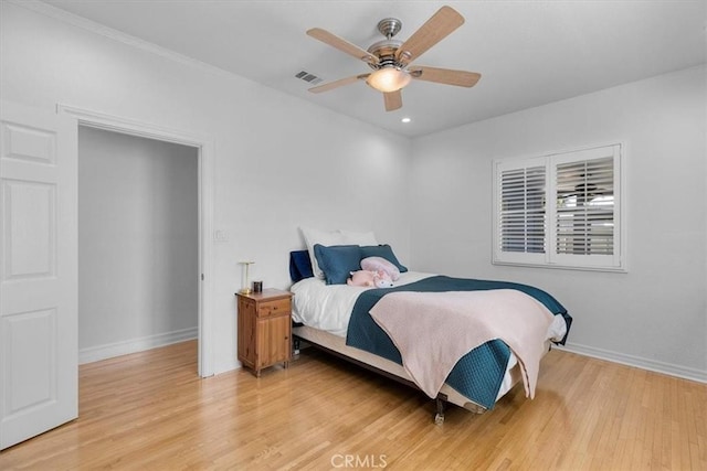 bedroom featuring visible vents, baseboards, and light wood-style flooring